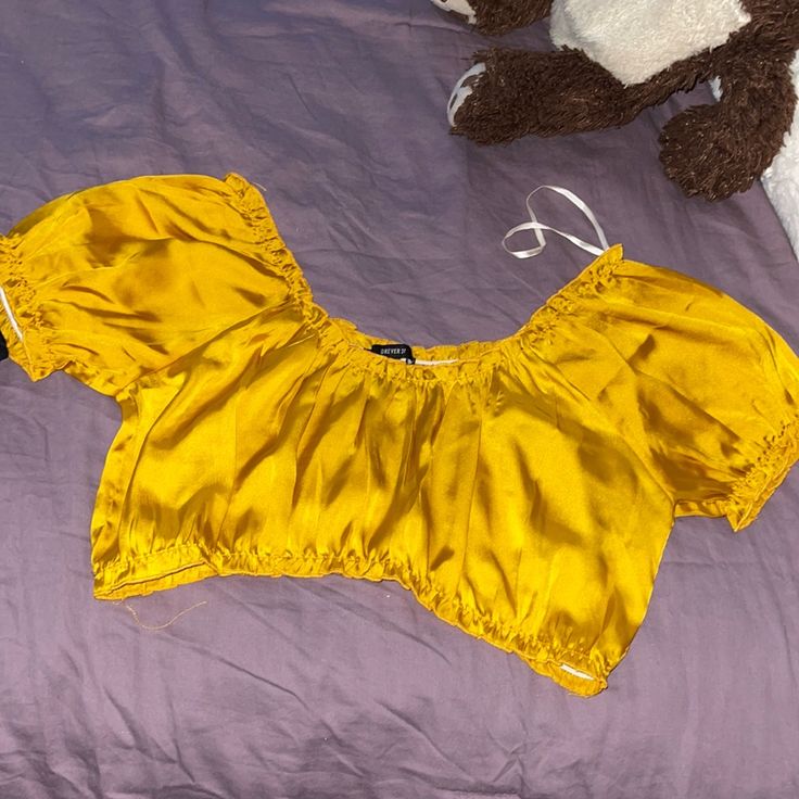 Silky Yellow Crop Top Gold Crop Top For Summer, Trendy Yellow Tops For Night Out, Yellow Summer Crop Top For Party, Trendy Yellow Crop Top, Yellow Crop Top For Summer Party, Chic Yellow Crop Top For Day Out, Trendy Yellow Crop Top For Day Out, Yellow Summer Party Crop Top, Trendy Gold Top For Spring