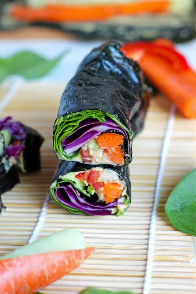 an assortment of sushi rolls with carrots, celery and other vegetables