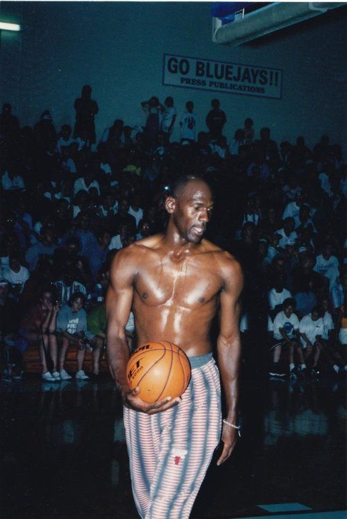 a man with no shirt holding a basketball