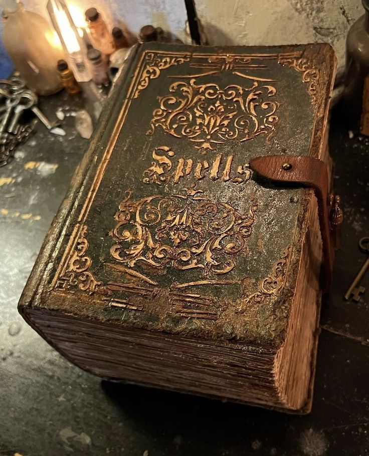 an old book sitting on top of a table next to a lamp and other items