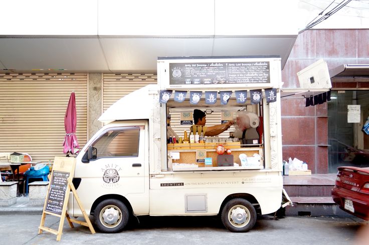 an ice cream truck parked in front of a building