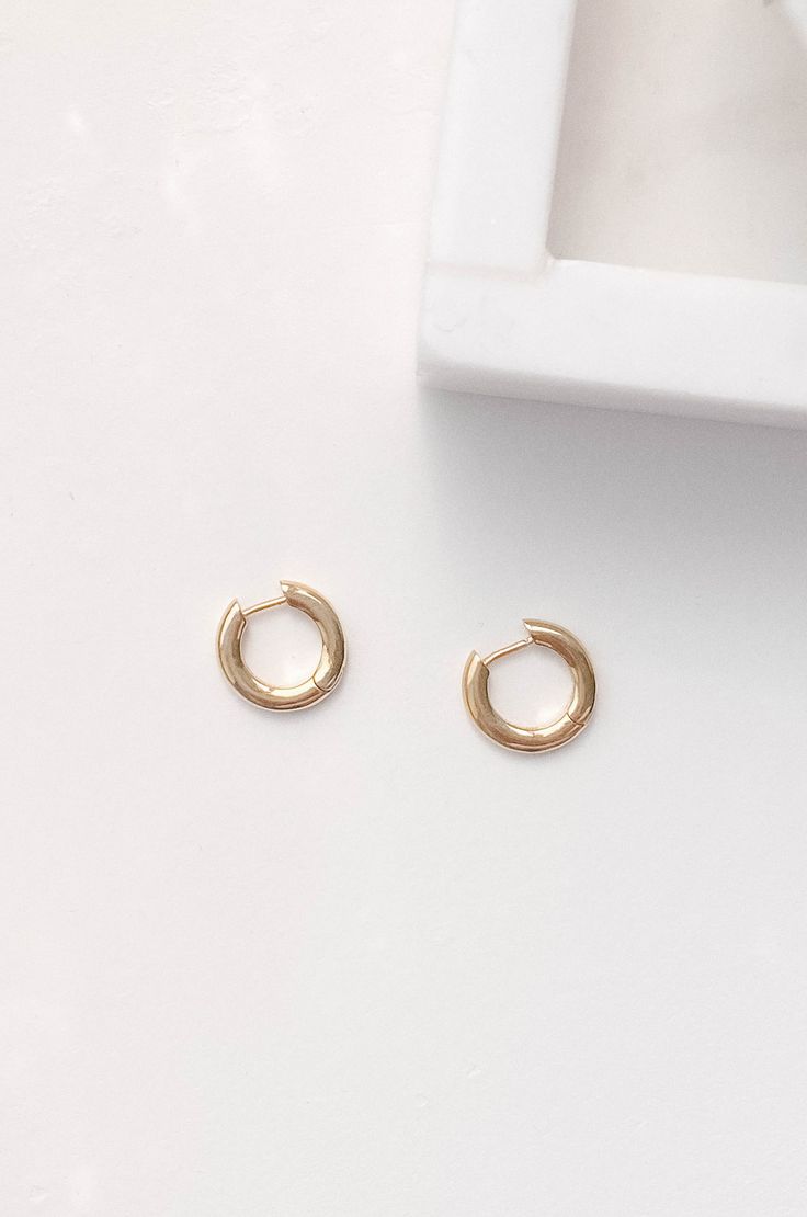 The chic huggie hoop are dipped in 14k gold and are hypoallergenic. They feature a minimalistic semi-thick round circle hoop. Made in brass and dipped in genuine 14K gold dipped Hypoallergenic Lightweight 15mm Simple Gold Huggie Earrings Tarnish Resistant, Simple Small Hoop Tarnish Resistant Huggie Earrings, Simple Tarnish Resistant Small Hoop Huggie Earrings, Simple Gold Small Hoop Huggie Earrings, Simple Gold Huggie Hoop Earrings, Simple Round Gold Huggie Earrings, Trendy Hypoallergenic Round Huggie Earrings, Trendy Hypoallergenic Huggie Earrings, Modern 14k Gold Filled Huggie Earrings For Everyday