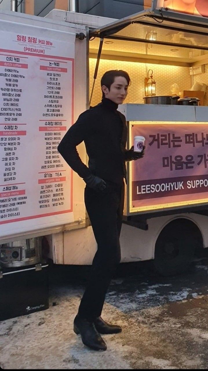 a man standing in front of a food truck with his hands on his hips and looking at the camera