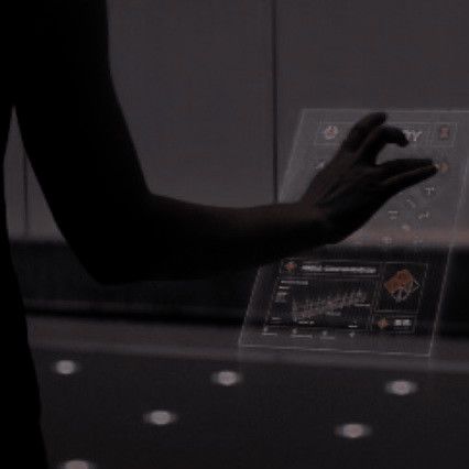 a person standing in front of a display case holding their hands out to touch the screen