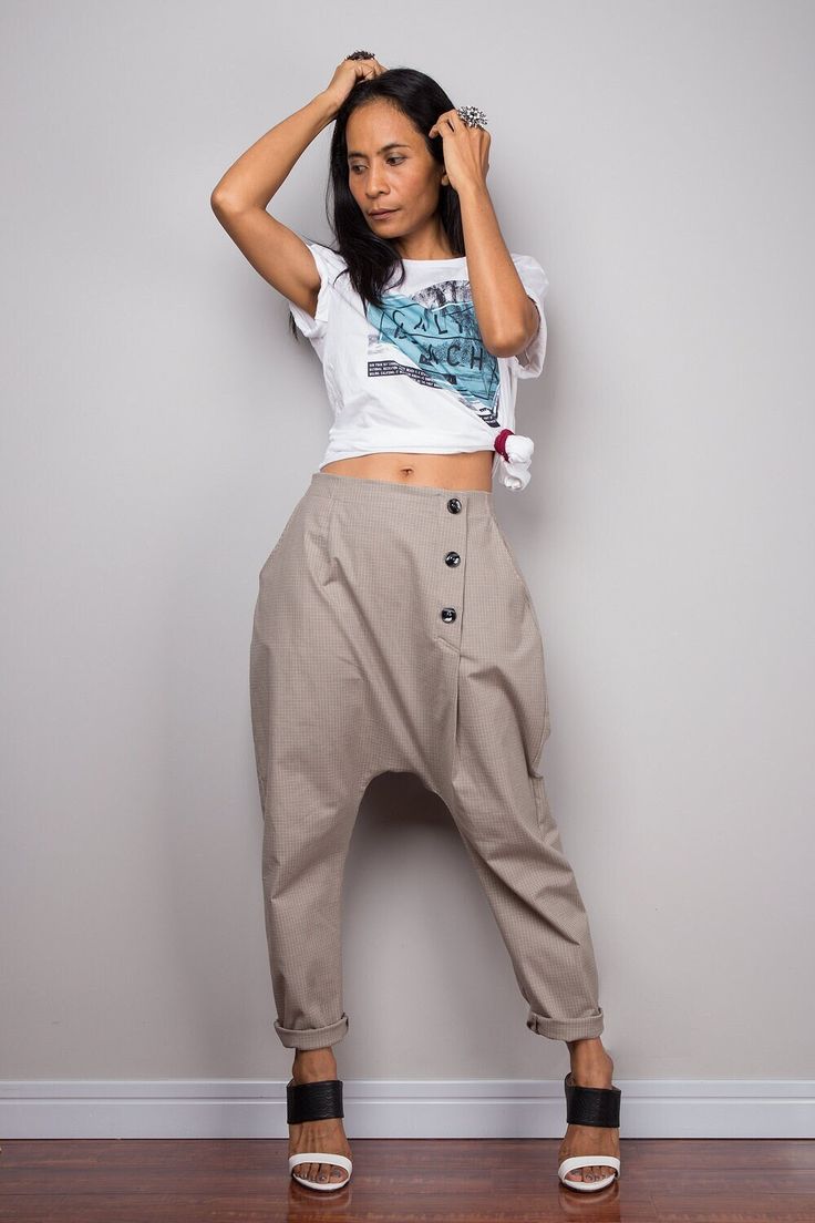 These  harem pants feature a smart linear and a fashionable low crotch design for a more comfy effect. Two pockets, a zipper on the front and extra buttons make these urban pants more attractive and the elastic on the back helps the fit  Made with the highest care this beautifully street styled garment will fit you perfectly. The idea is a support to mix and match with any kind of tops or shirt, depends on your own style and occasion.  These light brown natural linen pants come in One Size (free size)  Please make sure these pants will fit you before placing your order.  Waist: fits from 24 - 36" (inch) Hips: up to 44" (inch) Waist to crotch: 16" (inch) Length: 36" (inch) from waist til hem  NOTE :  * Model chest : 32", waist : 24" hips : 35"  * Combined Height is 5"6 > I'm 5"2 (158cm) and Natural Linen Pants, Linen Harem Pants, Unisex Pants, Drop Crotch Pants, Harem Pants Women, Baggy Trousers, Pants With Pockets, Brown Pants, Baggy Pants