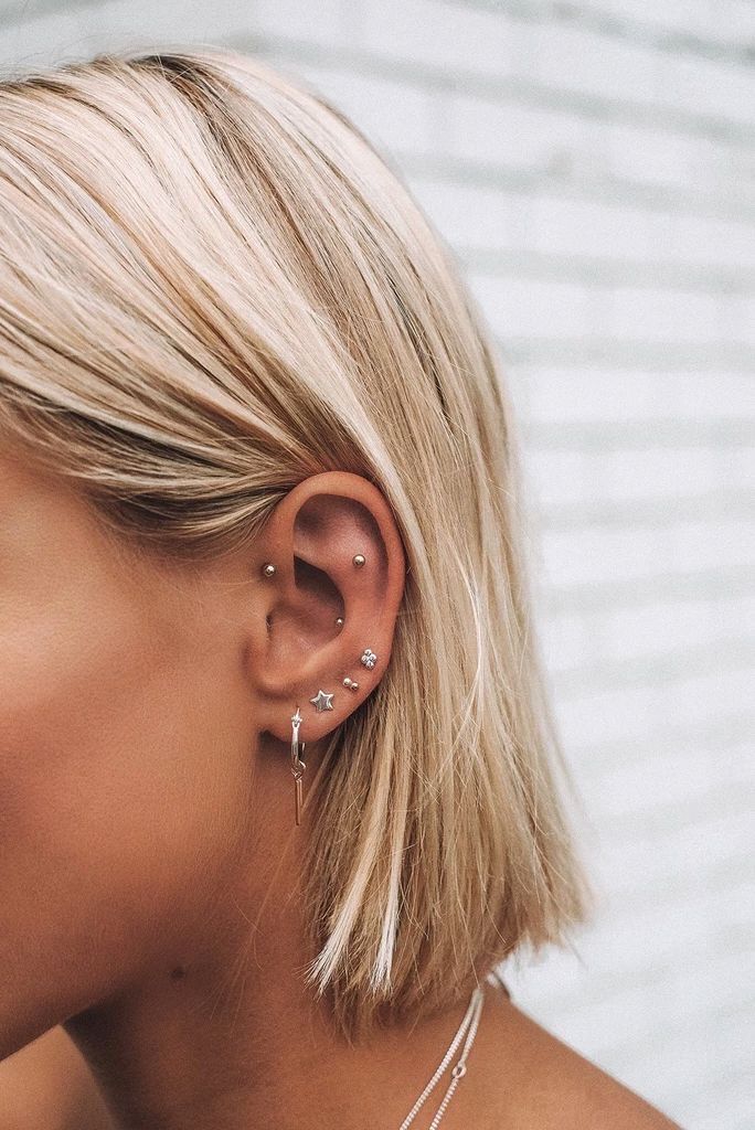 a blonde woman with ear piercings on her ears