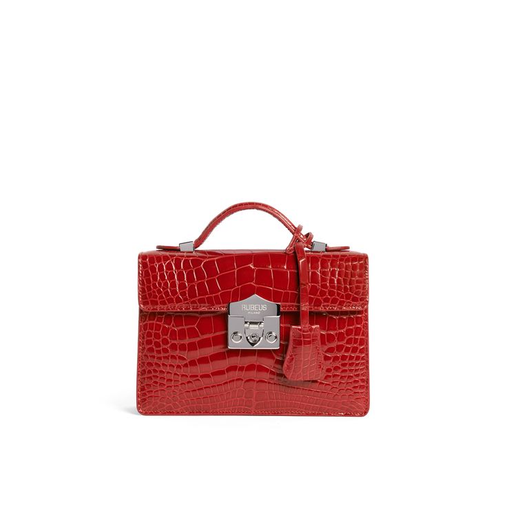 A signature Rubeus jewelled treasure that testifies to the power of classical elegance and Italian artistry. Born as the perfect Christmas present, the Flash Natale dominates all the year around. Small Natale Bag in rouge shining crocodile with palladium closure and adjustable crocodile strap. Interior slip pocket Measurements : 20x15x5.5 cm Made in Italy Luxury Red Bags With Crocodile Pattern, Red Evening Bag With Crocodile Pattern, Red Evening Bags With Crocodile Pattern, Red Crocodile Pattern Evening Bag, Elegant Bags With Silver-tone Hardware As A Gift, Elegant Crocodile Pattern Bag For Gift, Luxury Crocodile Pattern Bags For Gifts, Luxury Crocodile Pattern Bags As Gift, Elegant Red Bags With Silver-tone Hardware