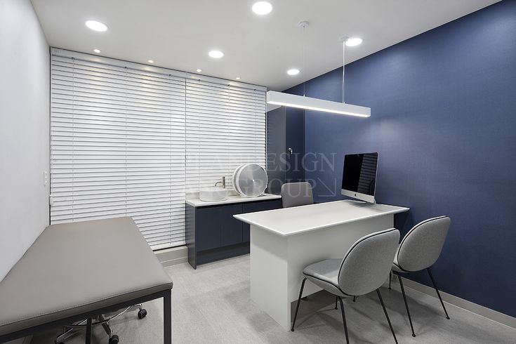 an office with blue walls and white chairs