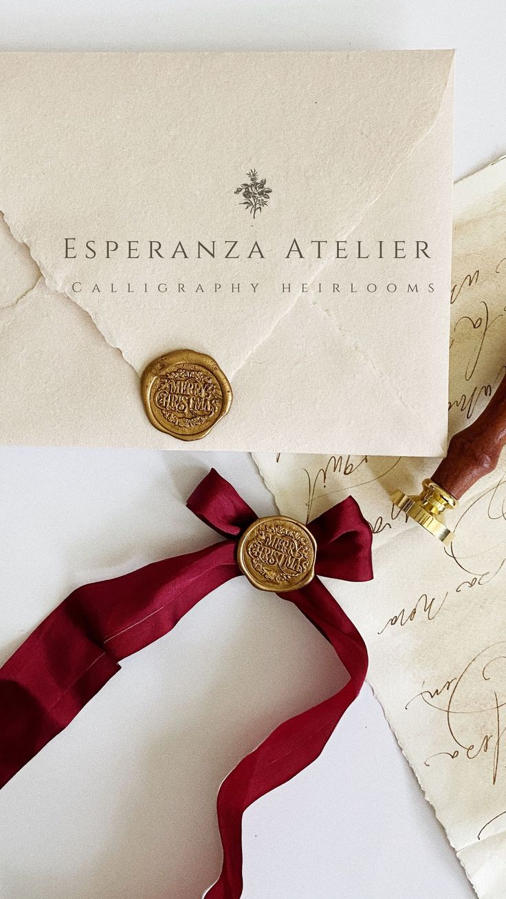 an envelope with wax stamp and red ribbon on it, next to some old letters