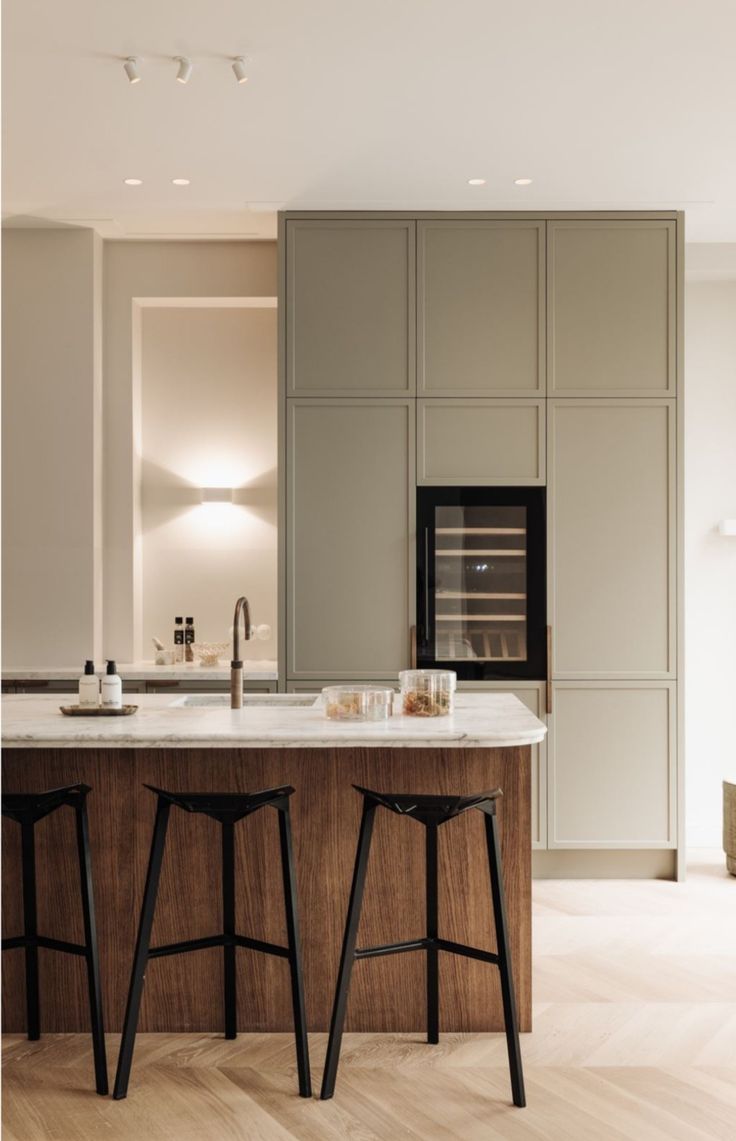 two stools are in front of the kitchen island