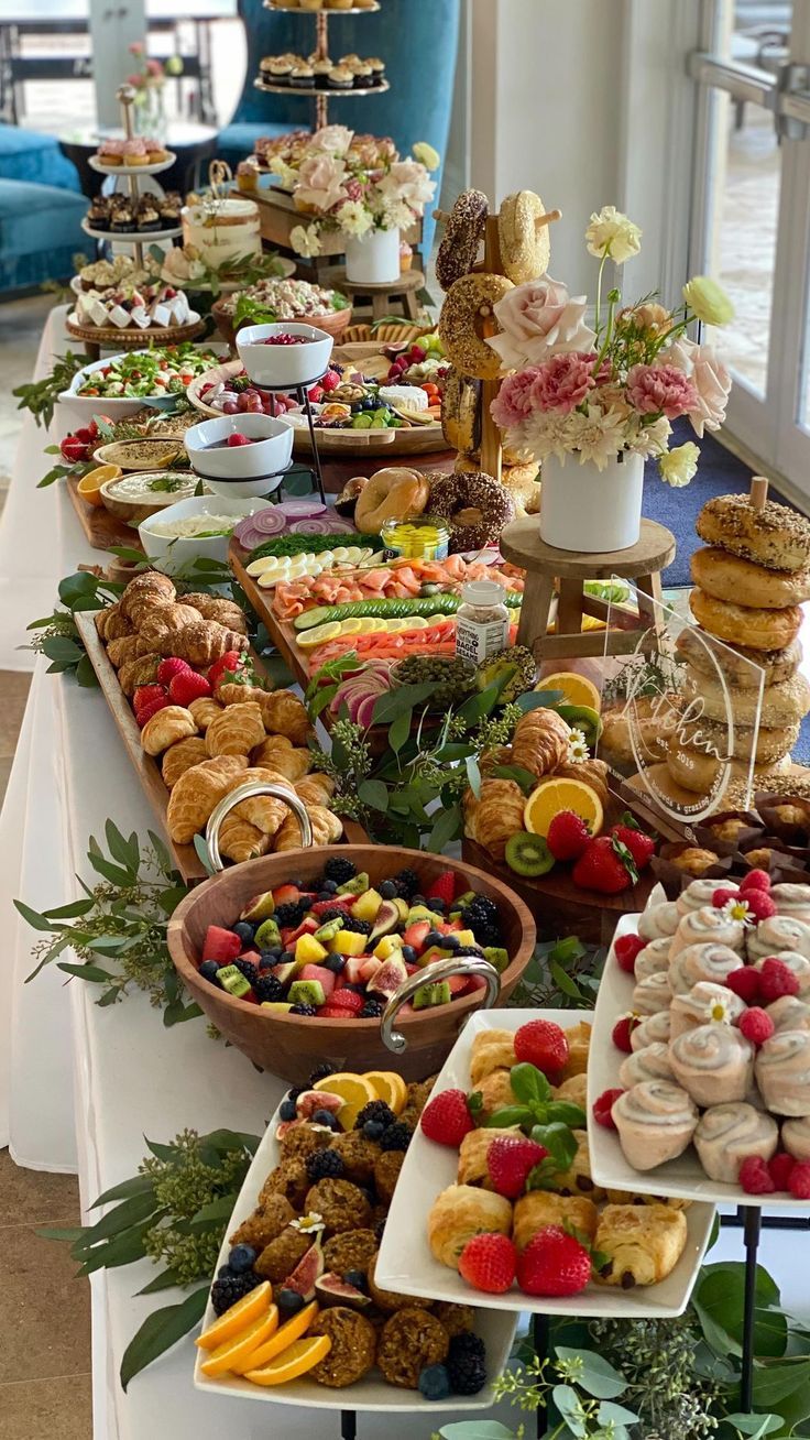 a long table filled with lots of different types of desserts and pastries on it