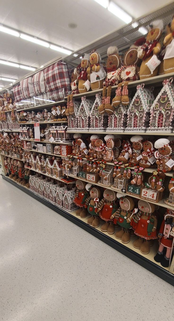 a store filled with lots of gingerbreads and other holiday decorations on display in front of the shelves