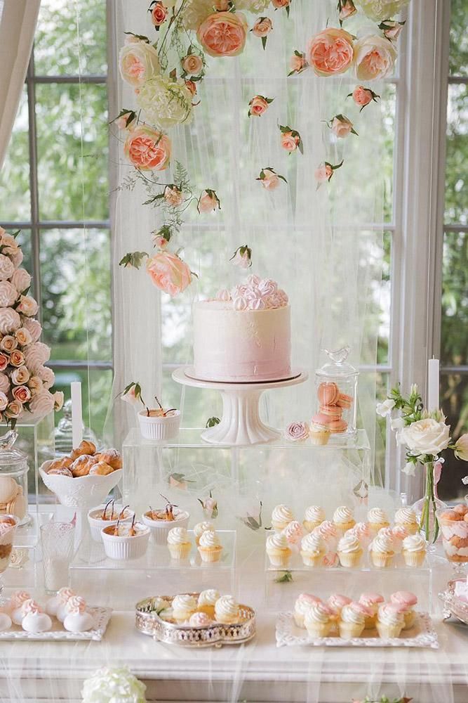 a table topped with lots of cakes and desserts