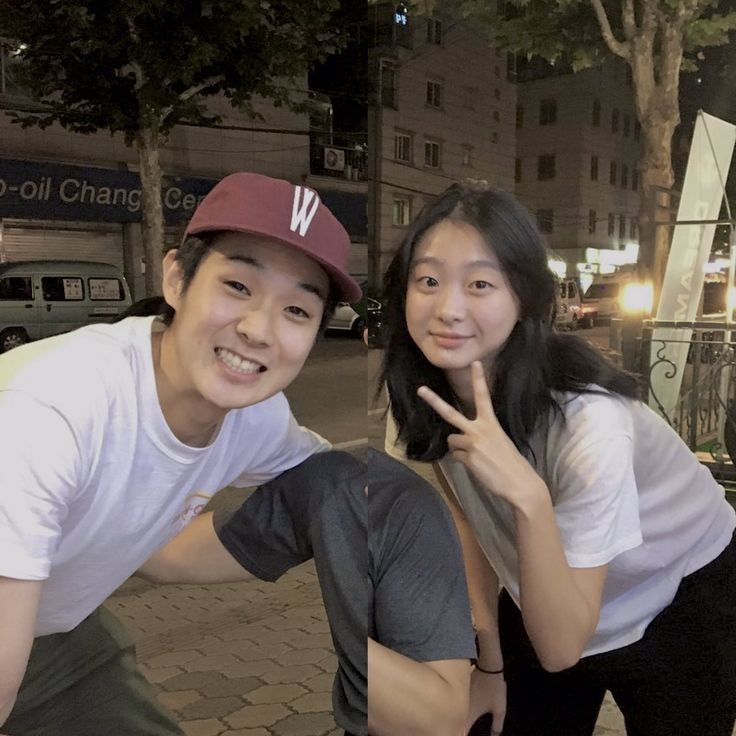 two people posing for a photo on the street