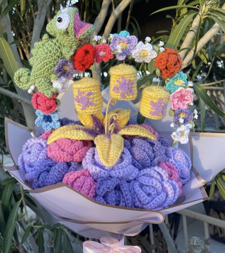 a bouquet of crocheted flowers and stuffed animals