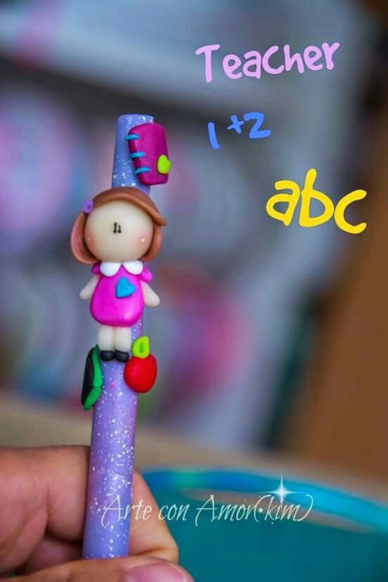 a hand holding a purple pen with a small doll on it's tip and the words teacher 1 - 2 abc