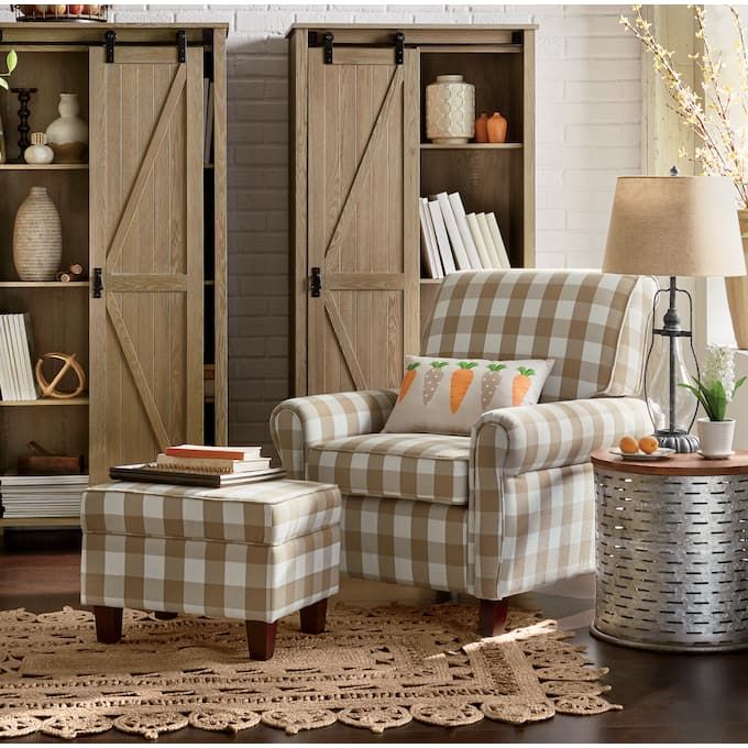 a chair and ottoman in a living room with wooden doors on the wall behind them