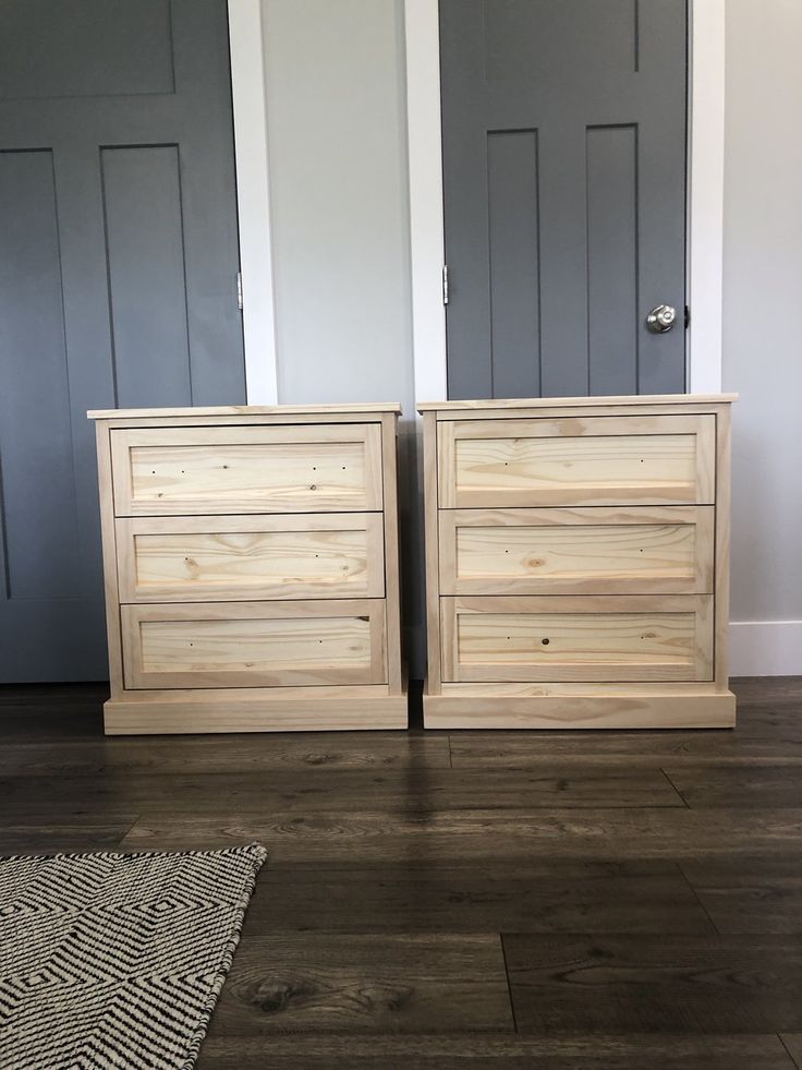 two wooden dressers sitting next to each other on top of a hard wood floor