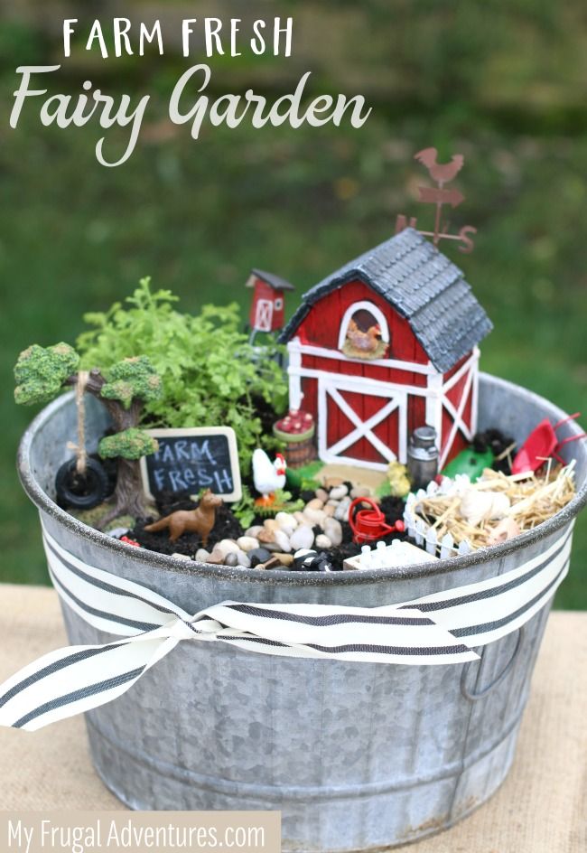 a metal bucket filled with miniature garden items