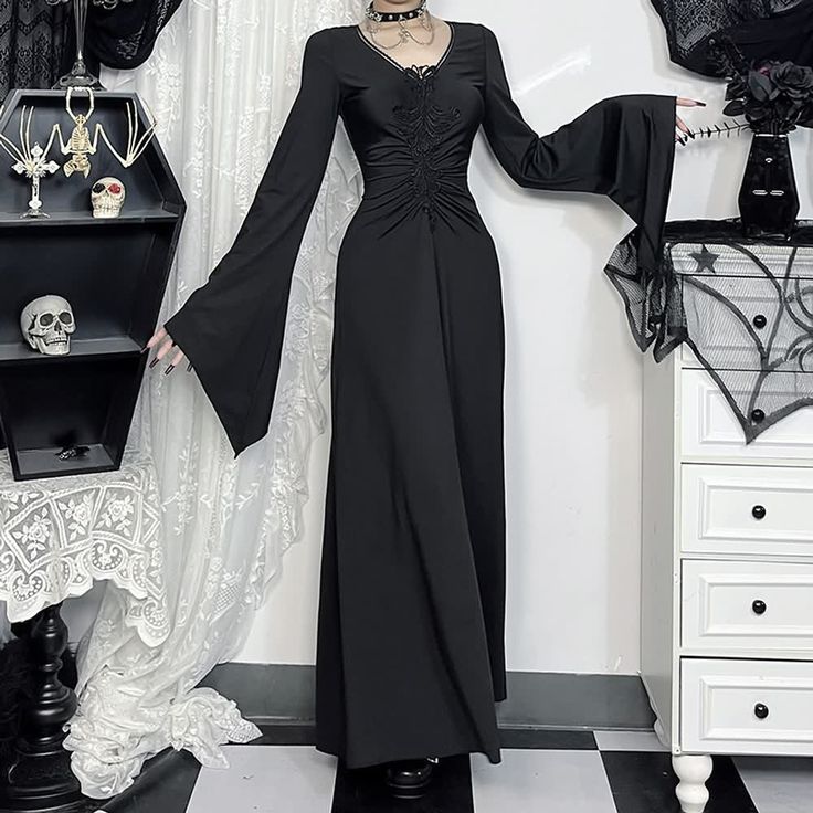 Indulge in the mysterious elegance of our Gothic Witch Long Sleeve Maxi Dress. Featuring flattering ruched details and a v-neckline that accentuates your curves, this dress exudes sophistication. The long bell sleeves and ankle-length design add drama, making it perfect for Halloween or any special occasion. Crafted from a luxurious polyester and spandex blend in a rich black hue, this dress pays homage to the iconic Addams Family, allowing you to embrace your inner enchantress in style. Ruched details and v-neck for a flattering fit Long bell sleeves for dramatic flair Ankle-length design for elegant sophistication Luxurious polyester and spandex blend Rich black color inspired by the Addams Family Kawaii Socks, Gothic Witch, Long Bell Sleeves, Kawaii Jewelry, Addams Family, Long Sleeve Maxi, Short Socks, Headband Hairstyles, Hair Accessories Headbands