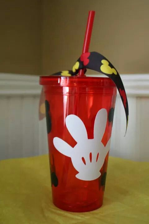 a plastic cup with a straw in the shape of a bunny on it sitting on a table