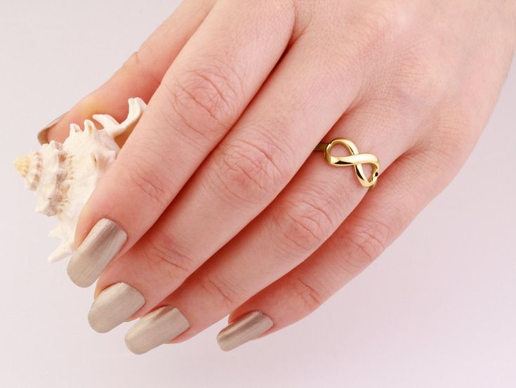 This Infinity Solid Gold Ring is perfect for stacking with other gold rings or wearing it by itself for an elegant look. * Item Details > Materials: 14K Solid Yellow Gold > Available: 14K Yellow Gold, Rose Gold, White Gold and 18K Yellow Gold, Rose Gold > Size: 4-10 US >Personalization is available > Stamps:  14K 18K G&D  > Made in USA with Love and Care by Jewelry Designer Gregory Simon > Brand: G&D Unique Designs *For the Dainty version of this ring please click the link below: https://www.ets Modern Twist Infinity Stackable Rings As Gift, Gold Stackable Infinity Rings With A Modern Twist, Gold Infinity Stackable Rings With A Modern Twist, Gold Stackable Rings With Modern Twist In Infinity Shape, Modern Twist Gold Infinity Stackable Rings, Infinity Shape Stackable Fine Jewelry Rings As Gift, Gold Infinity Stackable Rings For Wedding, Fine Jewelry Infinity Stackable Rings As Gift, Fine Jewelry Stackable Infinity Rings As Gift