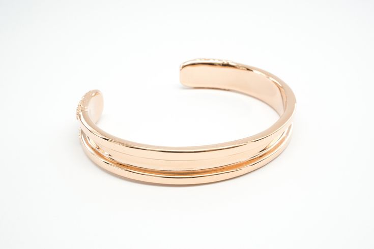 Hair tie bracelet in stainless steel with rose gold ionized plated finish one size, best fits wrists up to 6-6.75" in circumference can accommodate both skinny and thick hair tie elastics This stylish bracelet doubles as a hair tie holder that keeps your wrist indent-free! The Bittersweet hair tie bangle is sure to become your favorite and most useful accessory. Carry a hair elastic on your wrist in a way that’s elegant and versatile whether you are heading to work, dressing up, or working out! Adjustable Modern Rose Gold Bangle, Adjustable Rose Gold Bangle With Polished Finish, Adjustable Polished Rose Gold Bangle, Modern Adjustable Rose Gold Bracelets, Adjustable Elegant Rose Gold Cuff Bracelet, Adjustable Rose Gold Minimalist Cuff Bracelet, Adjustable Luxury Rose Gold Cuff Bracelet, Luxury Adjustable Rose Gold Cuff Bracelet, Rose Gold Metal Bracelet With Polished Finish