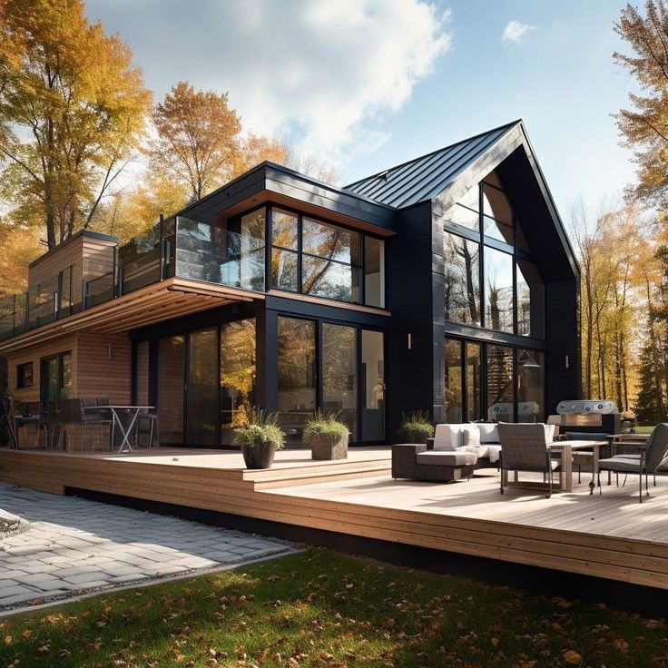 a modern house in the woods with deck and patio