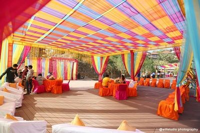 colorfully decorated outdoor event with tables and chairs