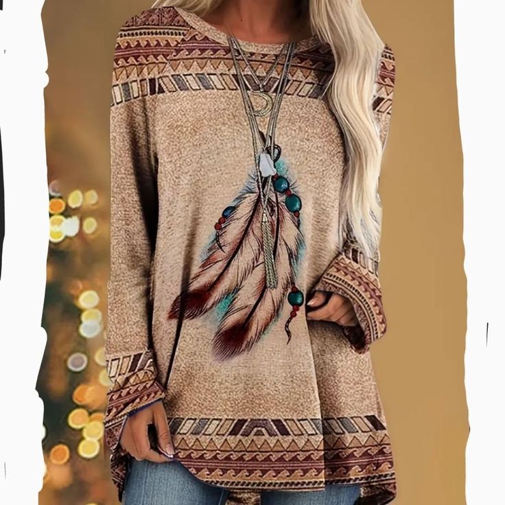 Western Graphic Print Design Long Line Long Sleeve Crew Neck Top. Versatile, Can Dress Up Or Dress Down. Easy Care And Machine Washable. Camel Color With A Feather Design . Fall Crew Neck Blouse For Beach, Casual Brown Blouse For Winter, Beige Crew Neck Blouse For Fall, Beige Long Sleeve Tops With Boho Print, Beige Boho Print Long Sleeve Tops, Casual Beige Blouse For Fall, Beige Long Sleeve Tops For Vacation, Long Sleeve Beige Tops For Vacation, Beige Blouse For Fall Vacation