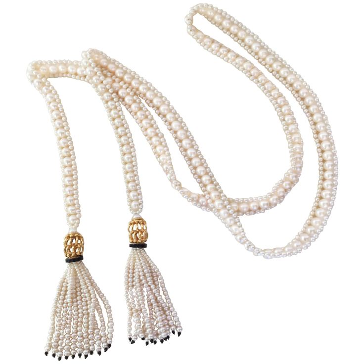 This intricately woven handmade rope sautoir is made of 6.5 mm and 2.5mm white pearls. The tassels are topped with large gold plated intertwined beads, followed by a onyx rondelles hand decorated with fine seed pearls and finished with subtlety graduated pearl tassels. and completed with small black onyx beads. Sautoir measures 47" from end of tassel. Tassels are 3.25" in length each. This timeless and size-less is elegant with limitless options. *Brooch is optional, but can be sold for an addit Pearl Tassels, Necklaces White, Necklaces Beaded, White Beaded Necklaces, Graduation Necklace, Beaded Tassel Necklace, Braided Necklace, Onyx Necklace, Necklace Pearl