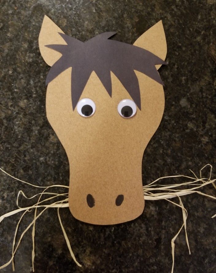 a paper horse head with eyes on it