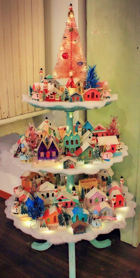 a small christmas tree with houses on it