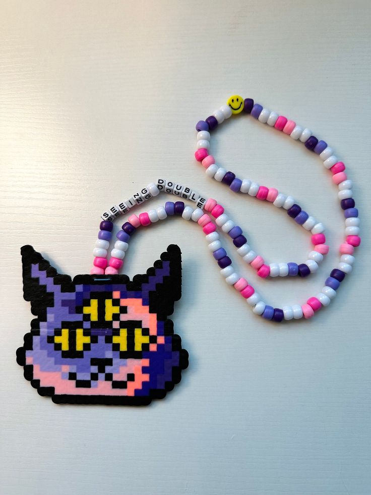 Cheshire Cat/Any Cat perler for your next rave! Everything is handmade by myself and always made with love!  PLUR ❤️ Rave Fuse Beads, Rave Trinkets, Rave Crafts, Kandi Creations, Kandi Designs, Bead Templates, Kandi Necklace, Perler Designs, Diy Kandi Bracelets