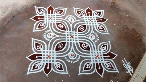 a white and brown design on the ground with red circles around it that is drawn in chalk