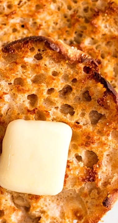 a piece of cheese is sitting on top of some kind of bread that has been cooked