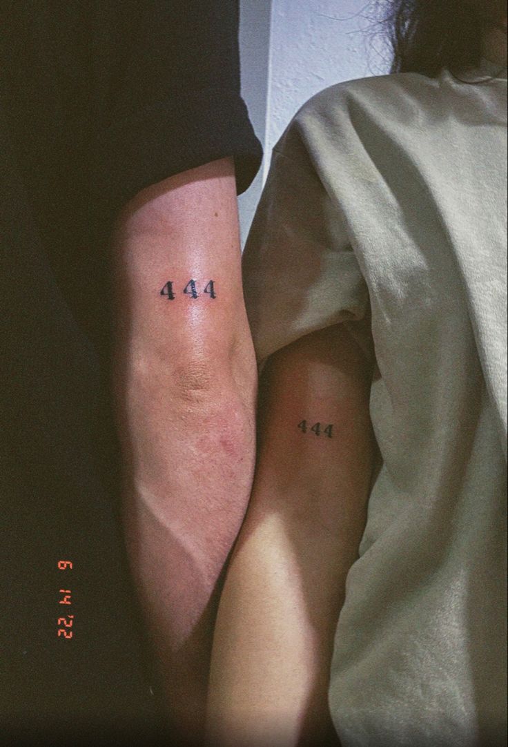 two people with small tattoos on their arms