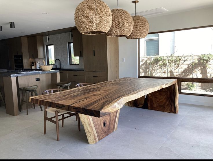 a large wooden table sitting inside of a kitchen