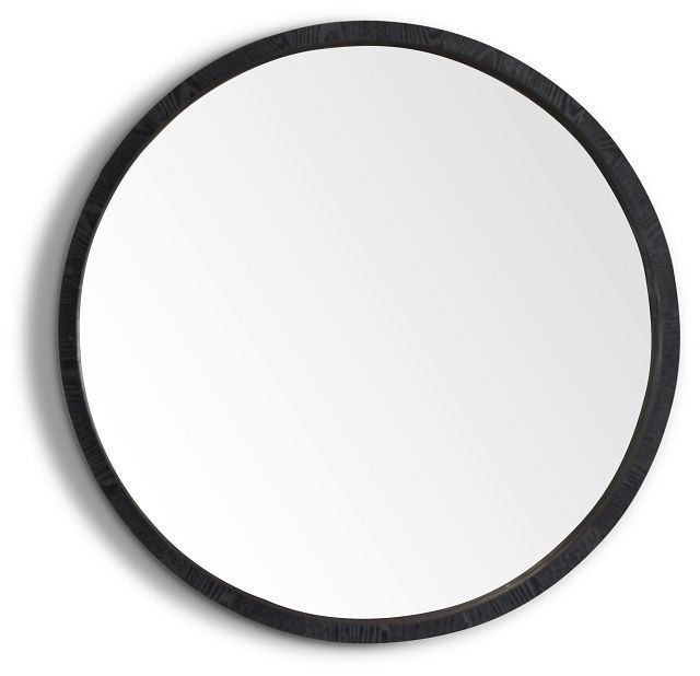 a round mirror on the wall with black trimmings and an oval frame, in front of a white background