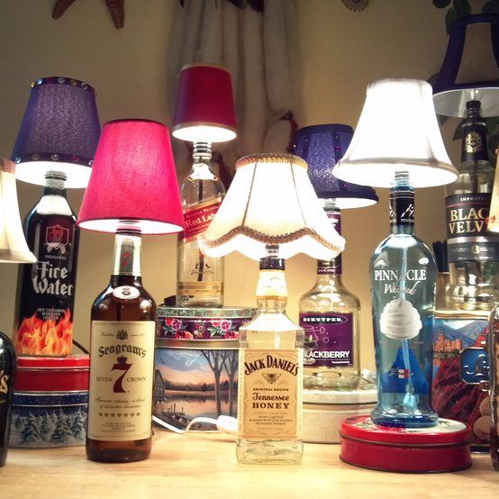 a table topped with lots of bottles and lamps