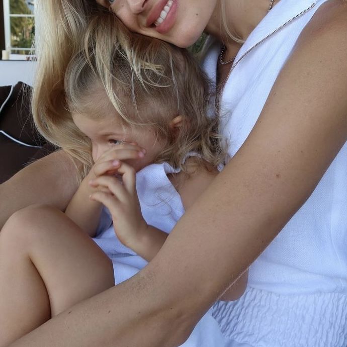 a mother and daughter hugging each other