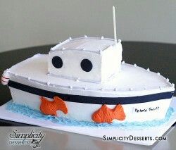 a cake made to look like a boat with two fish on the front and side