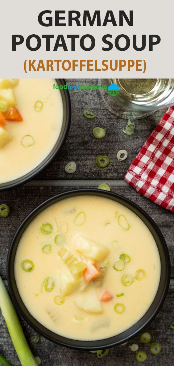 two black bowls filled with soup on top of a table next to celery