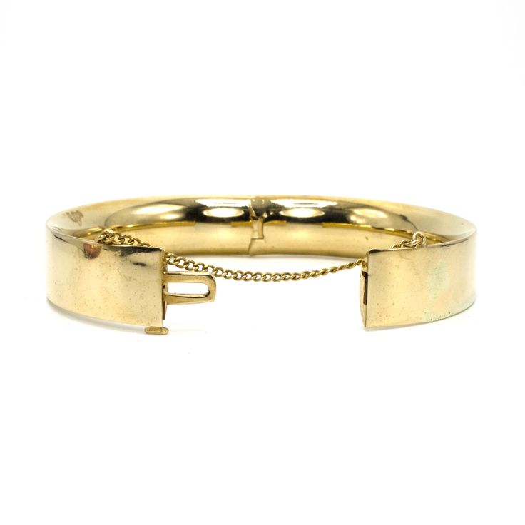 B.A. Ballou was founded in 1868 and continues to produce jewelry today. It is one of the oldest extant manufacturers of American jewelry. This lovely bangle is made of 14 karat yellow gold (the clasp is stamped "14K B.A.B.") and features a safety chain, which ensures the bracelet remains on the wearer should its clasp fail. This clasp is tight as new and the bracelet comes pre-engraved with a trigram that reads "MSM." Metal: 14K Yellow Gold Inside Diameter: 2.5 in. (average size) Antique Oval Bangle For Formal Occasions, Victorian Gold Bangle Bracelet For Formal Events, Hinged 14k Gold Bracelet, Vintage Gold Bracelet With Polished Finish For Formal Occasions, Vintage Yellow Gold Bangle Bracelet, Classic Yellow Gold Jewelry With Box Clasp, Antique Yellow Gold Bangle For Formal Occasions, Antique Yellow Gold Bracelet For Formal Occasions, Victorian Polished Bracelets For Formal Occasions