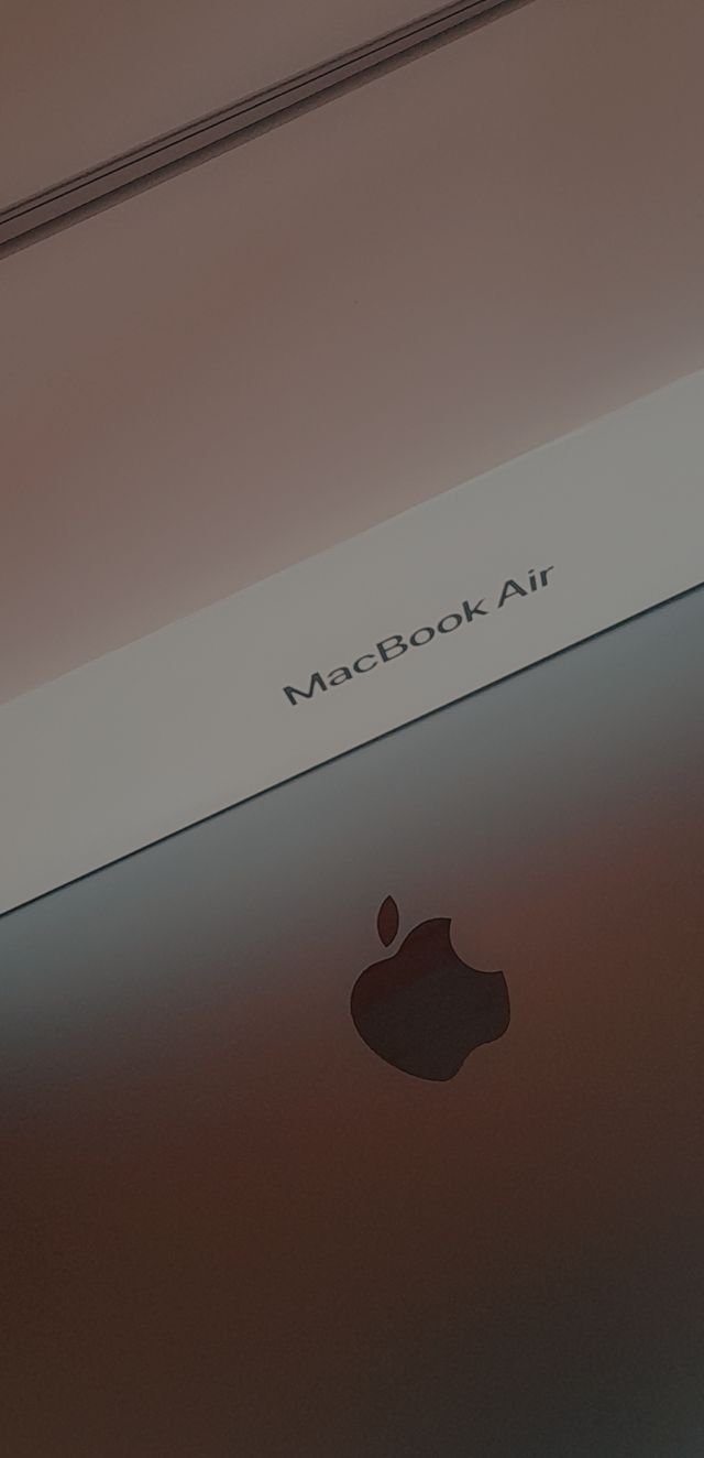 an apple macbook air is shown with the logo on it's back side