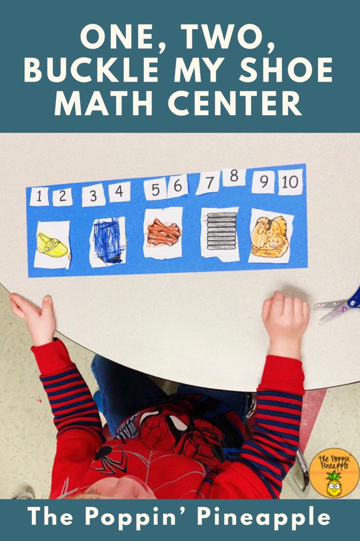 a young boy holding up a paper cutout with numbers on it and the words, one two, buckle my shoe math center