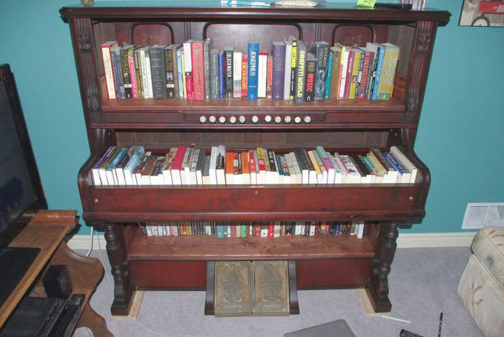 there is a piano with books on it in the living room