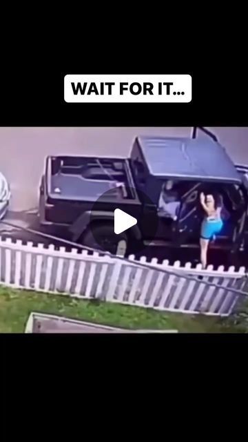 a woman in a blue swimsuit standing next to a black suv with the words wait for it