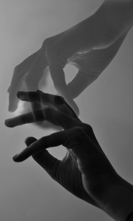 two hands reaching towards each other in the air with their fingers extended out to touch something