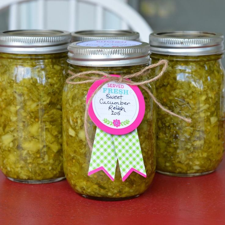 three jars filled with green stuff sitting on top of a table